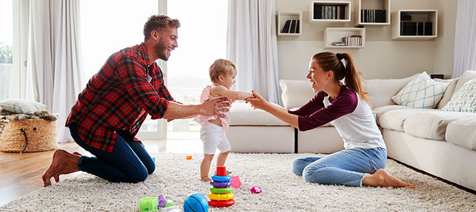 A imagem mostra um exemplo de pais brincando com o bebê.